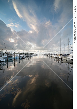 Summer cloudscape reflected in calm water of Dinner Key in Miami, Florida. 78653770