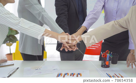 Group of Asian successful business people stacking hands together to cheer up team together in meeting, communicate, discuss, and working with colleagues in office. People lifestyle.Corporate teamwork 78654358