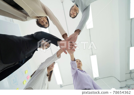 Group of Asian successful business people stacking hands together to cheer up team together in meeting, communicate, discuss, and working with colleagues in office. People lifestyle.Corporate teamwork Group of Asian successful business people stacking hands together to cheer up team together in meeting, communicate, discuss, and working with colleagues in office. People lifestyle.Corporate teamwork 78654362