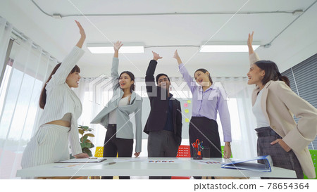 Group of Asian successful business people stacking hands together to cheer up team together in meeting, communicate, discuss, and working with colleagues in office. People lifestyle.Corporate teamwork Group of Asian successful business people stacking hands together to cheer up team together in meeting, communicate, discuss, and working with colleagues in office. People lifestyle.Corporate teamwork 78654364