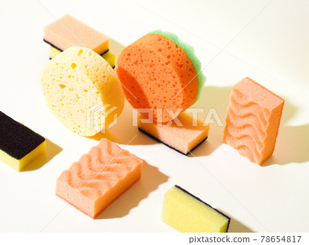 Foam rubber sponges in different shapes on yellow Foam rubber sponges in different shapes on yellow 78654817