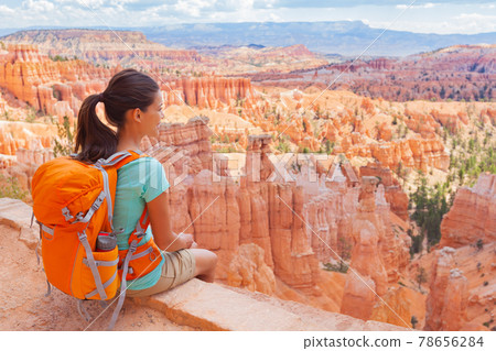 USA Hiker woman in Bryce Canyon hiking relaxing looking at view during hike wearing backpack on summer travel. Bryce Canyon National Park landscape, Utah, United States USA Hiker woman in Bryce Canyon hiking relaxing looking at view during hike wearing backpack on summer travel. Bryce Canyon National Park landscape, Utah, United States 78656284