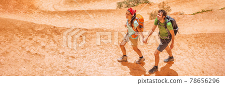 Hiking hikers tourists on summer trail trekking on mountain path with backpacks wearing hiking boots. Panoramic banner of active lifestyle couple traveling outdoor Hiking hikers tourists on summer trail trekking on mountain path with backpacks wearing hiking boots. Panoramic banner of active lifestyle couple traveling outdoor 78656296