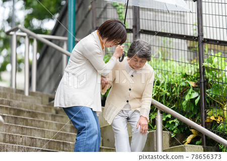 Senior long-term care female rainy season umbrella 2 people stairs Senior long-term care female rainy season umbrella 2 people stairs 78656373