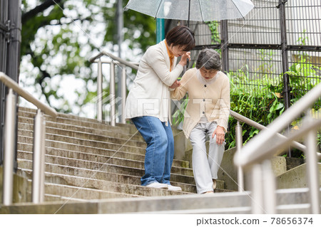 Senior long-term care female rainy season umbrella 2 people stairs 78656374