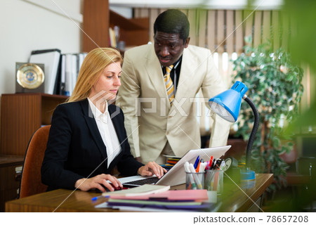 African american businessman with female colleague working in office African american businessman with female colleague working in office 78657208