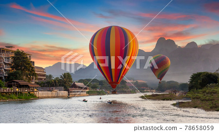 Nam Song river at sunset with hot air balloon in Vang Vieng, Laos, Beautifull landscape on the Nam Song River in Vang Vieng, Laos. Nam Song river at sunset with hot air balloon in Vang Vieng, Laos, Beautifull landscape on the Nam Song River in Vang Vieng, Laos. 78658059