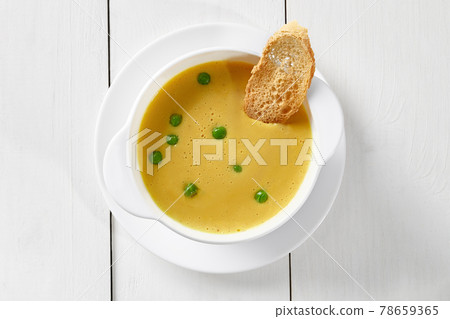 Pea cream soup in turkey broth with toast Pea cream soup in turkey broth with toast 78659365