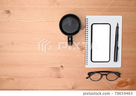 Top view mobile phone, notebook, glasses and coffee cup on wooden desk. 78659463