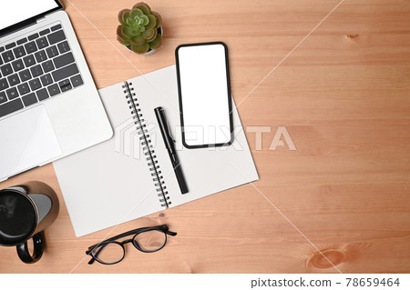 Top view mobile phone, laptop, notebook an glasses on wooden table. 78659464