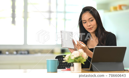 Young Asian businesswoman conference of colleagues through a tablet. Young Asian businesswoman conference of colleagues through a tablet. 78660643
