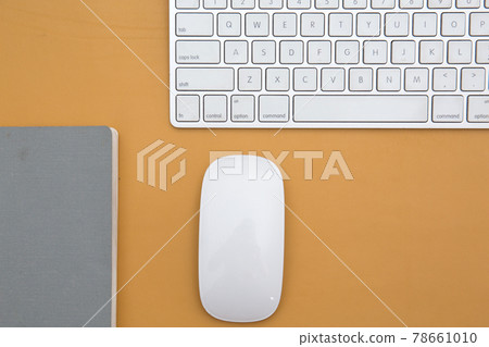 Business concept. Photo of wireless mouse and keyboard on yellow leather table Business concept. Photo of wireless mouse and keyboard on yellow leather table 78661010