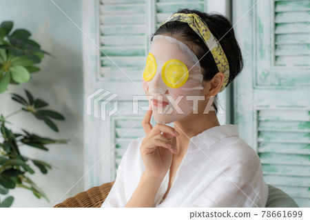 Young woman doing a face pack 78661699