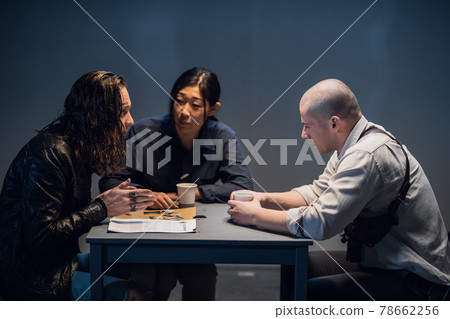 An experienced investigator and a female police officer interrogate the suspect An experienced investigator and a female police officer interrogate the suspect 78662256