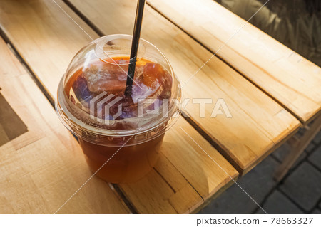 Take away coffee in plastic glass on wooden table Take away coffee in plastic glass on wooden table 78663327