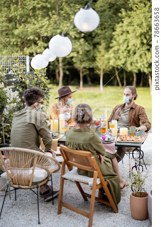 Friends in face mask dining outdoors Friends in face mask dining outdoors 78663658