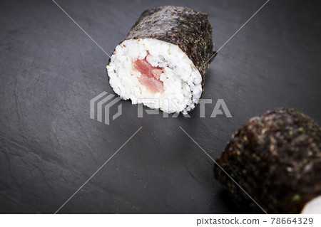 Close-up of a sushi roll for cutting. Asian food. Healthy food concept 78664329