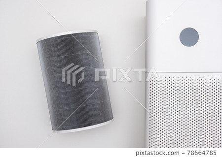 Indoor air purifier of white color close-up on a white background. Dust and allergy cleaner in the house. Indoor air purifier of white color close-up on a white background. Dust and allergy cleaner in the house. 78664785
