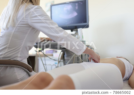 Doctor making ultrasound examination of pelvic organs to woman patient closeup Doctor making ultrasound examination of pelvic organs to woman patient closeup 78665002