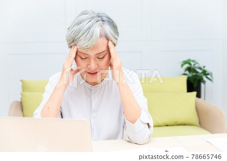 Elderly professional woman working from home during covid-19 pandemic Elderly professional woman working from home during covid-19 pandemic 78665746