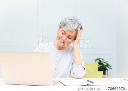 Elderly professional woman working from home during covid-19 pandemic Elderly professional woman working from home during covid-19 pandemic 78667070