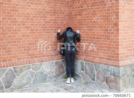 young girl stands near the wall of a gothic church young girl stands near the wall of a gothic church 78668671