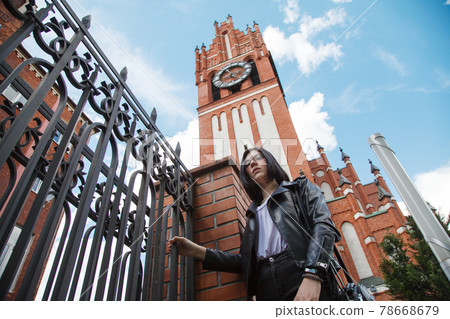 young girl stands near the gothic church young girl stands near the gothic church 78668679