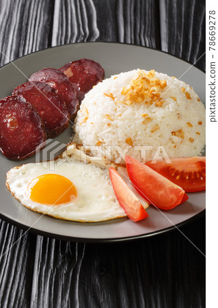Garlic rice served with fried egg and jerky close-up in a plate. vertical Garlic rice served with fried egg and jerky close-up in a plate. vertical 78669278