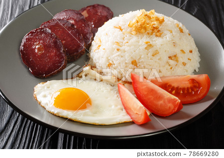 Sinangag also called garlic fried rice is a Filipino dish cooked by stir-frying pre-cooked rice with garlic close up in the plate. Horizontal Sinangag also called garlic fried rice is a Filipino dish cooked by stir-frying pre-cooked rice with garlic close up in the plate. Horizontal 78669280