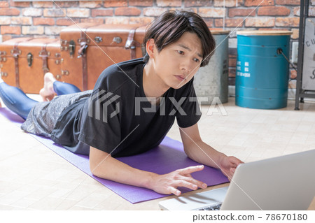 A young man checking muscle training videos on... - Stock Photo ...