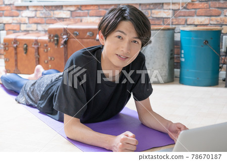 A young man checking muscle training videos on... - Stock Photo ...