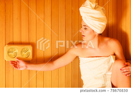 woman relaxing in wooden sauna room woman relaxing in wooden sauna room 78670830