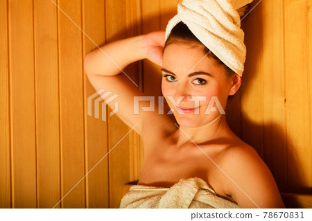 woman relaxing in wooden sauna room woman relaxing in wooden sauna room 78670831