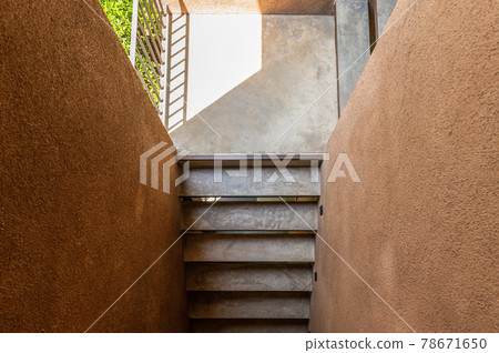 Cement stairs with sunlight in soil wall 78671650