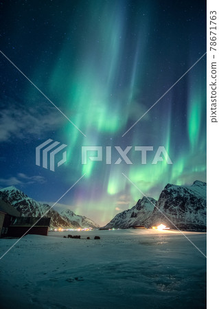Aurora borealis, Northern lights with stars glowing on snowy mountain in the night sky on winter at Lofoten Islands Aurora borealis, Northern lights with stars glowing on snowy mountain in the night sky on winter at Lofoten Islands 78671763