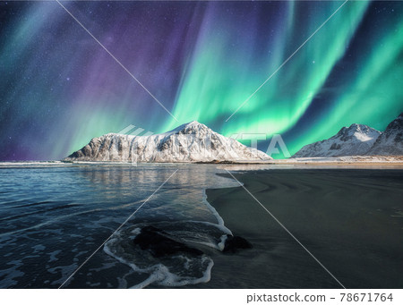Aurora Borealis, Northern Lights Above on snowy mountain in Skagsanden Beach at Lofoten Islands 78671764