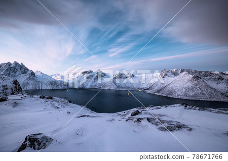 Snowy mountain range with ocean in arctic circle at Segla mount 78671766