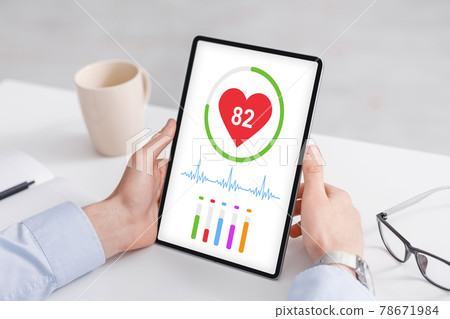 Cropped of man using healthcare application on digital tablet Cropped of man using healthcare application on digital tablet 78671984