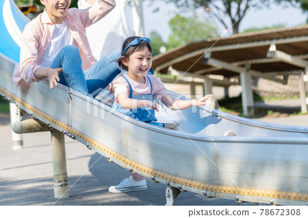 Young parents and children playing in the park Young parents and children playing in the park 78672308