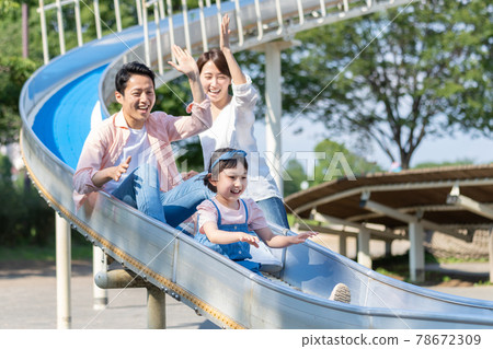 Young parents and children playing in the park Young parents and children playing in the park 78672309