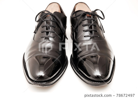 Black, well-maintained straight-tip leather shoes for ceremonial occasions 78672497