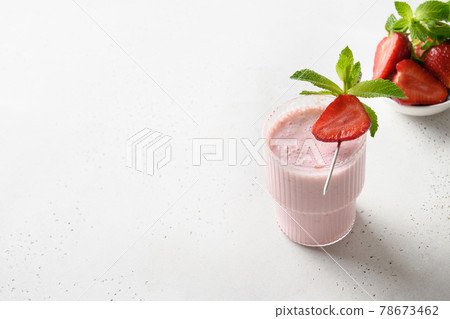 Indian strawberry lassi or milkshake on white background Indian strawberry lassi or milkshake on white background 78673462