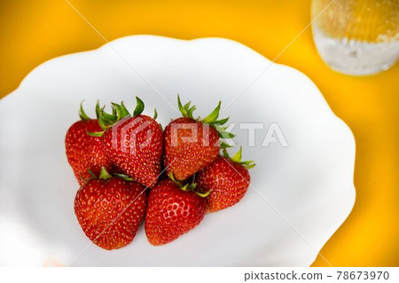 Many strawberries and drinks on a white plate Many strawberries and drinks on a white plate 78673970