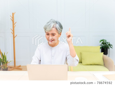 Elderly professional woman working from home during covid-19 pandemic Elderly professional woman working from home during covid-19 pandemic 78674592