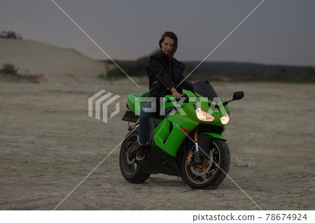 Cool woman in helmet on motorbike on beach 78674924