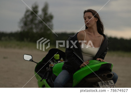 Cool woman in helmet on motorbike on beach Cool woman in helmet on motorbike on beach 78674927