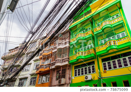 Colorful painted buildings coveredy by black tangled electricity wires. Colorful painted buildings coveredy by black tangled electricity wires. 78675099