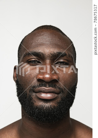 Close-up young African man isolated over white background. Concept of beauty, spa, well kept skin. 78675317