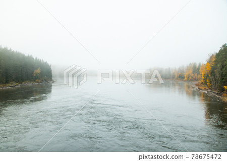 Beautiful autumn landscape of Kymijoki river waters in fog. Finland, Kymenlaakso, Kotka 78675472