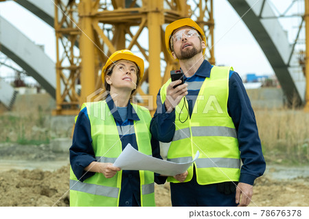 Two young builders looking upwards Two young builders looking upwards 78676378